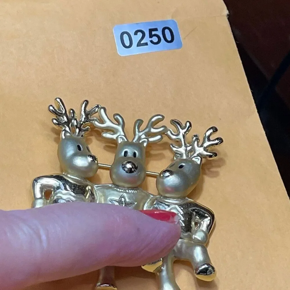 Vintage AJC three dancing deer gold tone brooch.